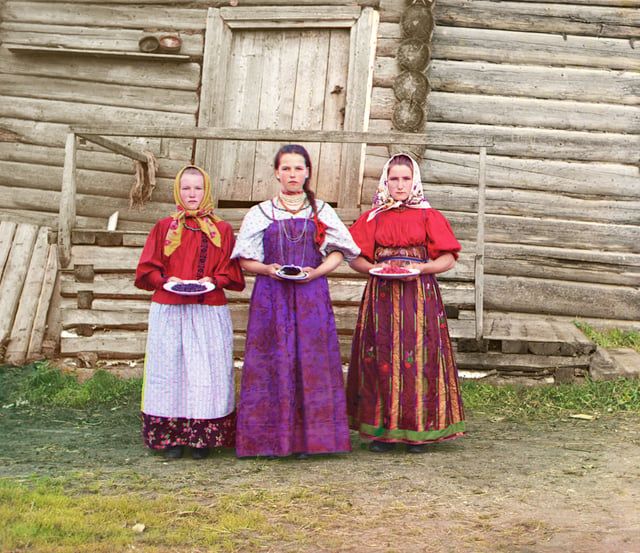 Young Russian peasant women in front of a traditional wooden house (ca. 1909 to 1915) taken by Prokudin-Gorskii