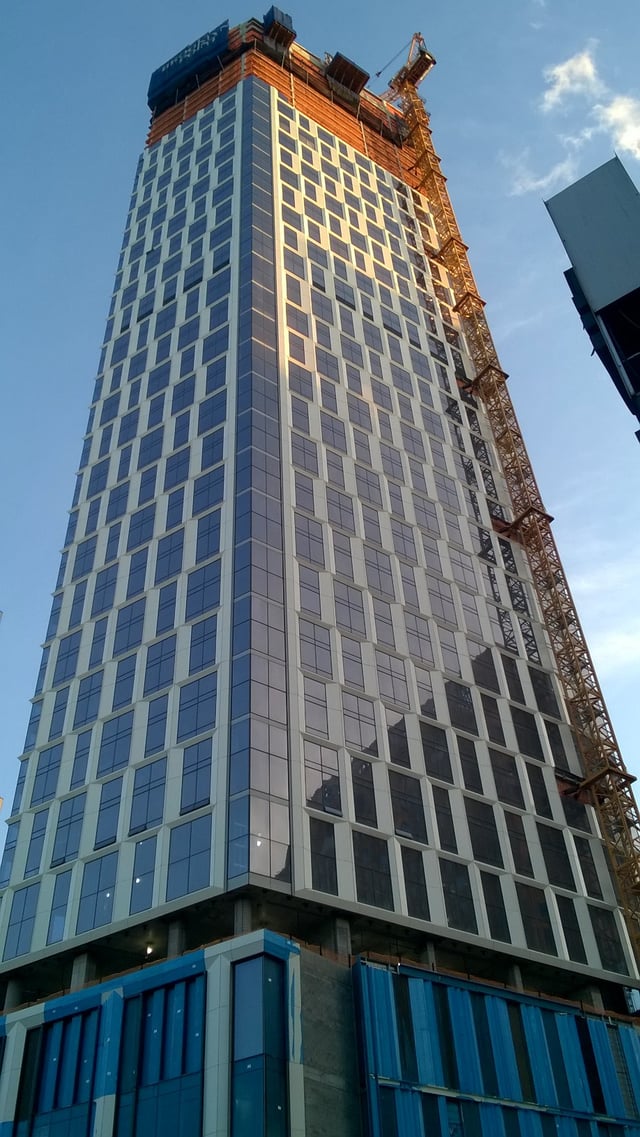 The Brooklyn Point skyscraper under construction in the City Tower complex within the borough of Brooklyn. At a height of 720 feet, it became the tallest building on Long Island following its topping out in April 2019.