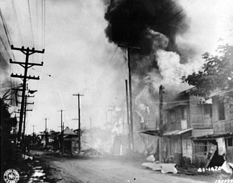 A burning building along Taft Avenue which was hit during the Japanese air raid in Barrio Parañaque, 13 December 1941.