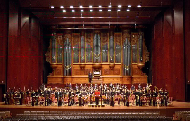 Apo Hsu and the NTNU Symphony Orchestra on stage in the National Concert Hall.