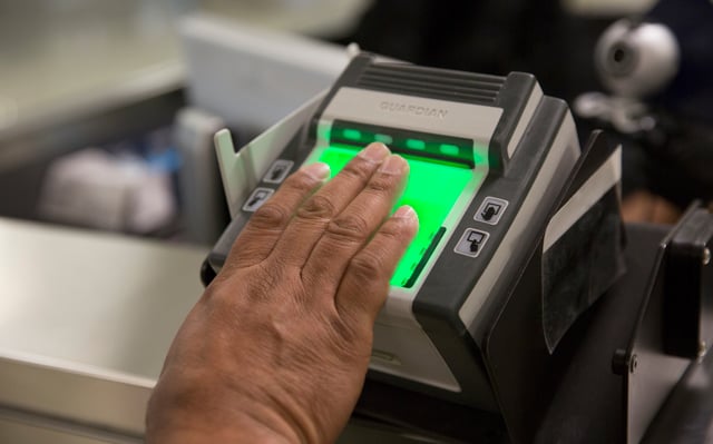 A fingerprint scanner at Dulles International Airport collects biometric data on visitors, which can be used for confirming identities.
