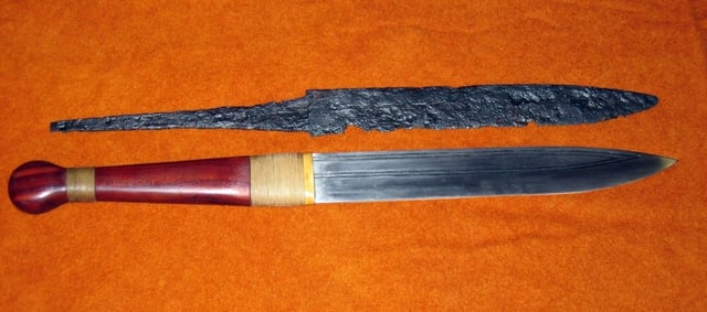 The remains of a seax together with a reconstructed replica