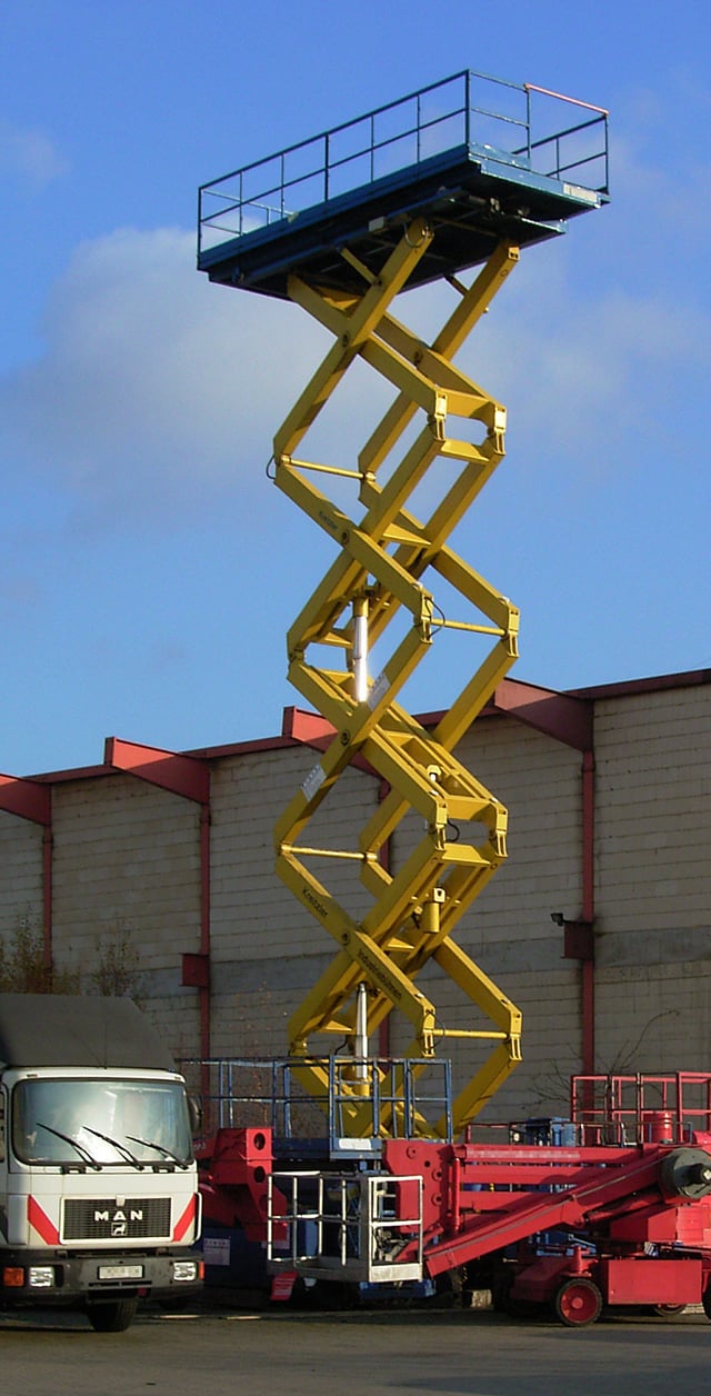 A mobile scissor lift, extended to near its highest position