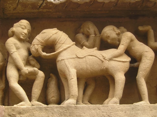 Man having intercourse with a horse, pictured on the exterior of a temple in Khajuraho.