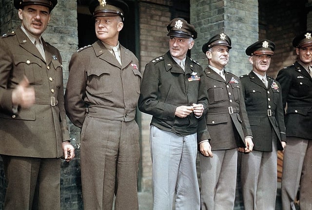 Awards ceremony at RAF Debden, April 1944, illustrating varying shades of olive drab and the M-1944 "Ike jacket". Light shade 33 on left, dark shade 51 on right. Trousers are shade 33, khaki shade 1, and drab shade 54. The three combinations at right are "pinks and greens".