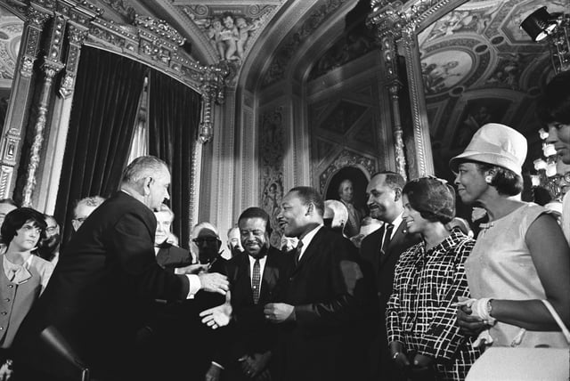 President Lyndon B. Johnson, Martin Luther King Jr., and Rosa Parks at the signing of the Voting Rights Act on August 6, 1965