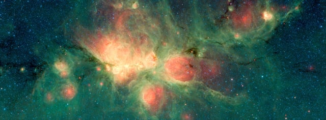 The Cat's Paw Nebula lies inside the Milky Way Galaxy and is located in the constellation Scorpius.Green areas show regions where radiation from hot stars collided with large molecules and small dust grains called "polycyclic aromatic hydrocarbons" (PAHs), causing them to fluoresce.(Spitzer space telescope, 2018)