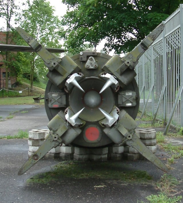 The rear section of an 8K14 missile, displayed at the Poznan Museum of Armaments - pl:Muzeum Uzbrojenia w Poznaniu, Poland. The fixed fins and the graphite vanes that control the missile's path can be seen