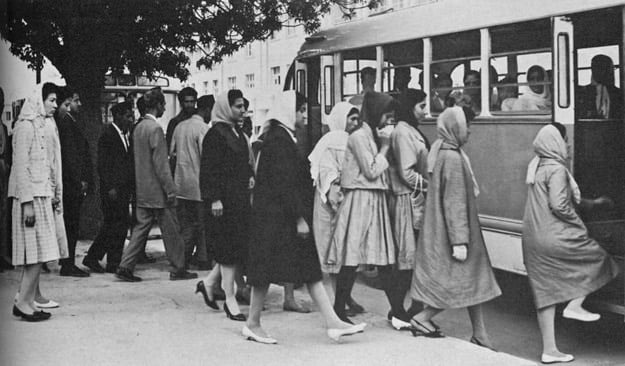 Men and women entering a public transport bus in the 1950s