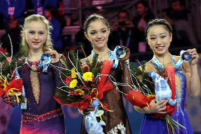Medvedeva (center) with Serafima Sakhanovich (left) and Wakaba Higuchi (right) at the 2014–15 JGP Final podium.