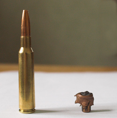 Expanding bullet loaded in a 6.5×55mm before and after expanding. The long base and small expanded diameter show that this is a bullet designed for deep penetration on large game. The bullet in the photo traveled more than halfway through a moose before coming to rest, performing as designed.