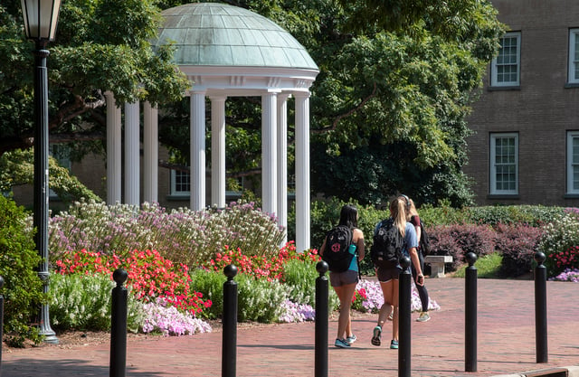 Students walk past the Old Well, a symbol of UNC-Chapel Hill for years