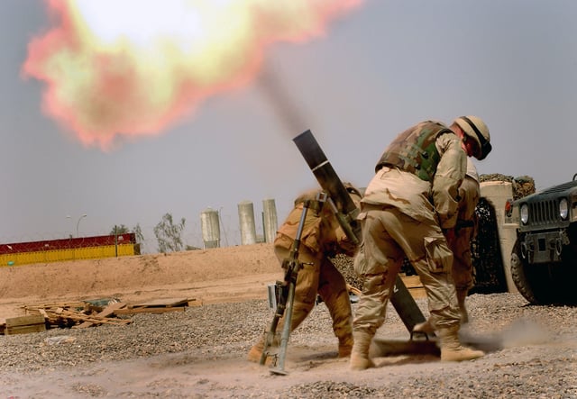U.S. troops fire mortars.
