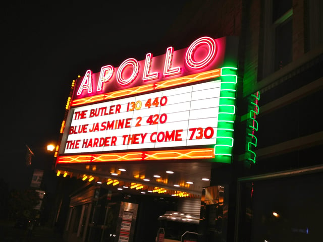 The Apollo Theater's iconic marquee at night.