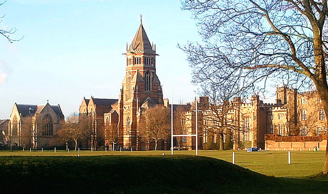 Rugby School in Rugby, Warwickshire, with a rugby football pitch in the foreground