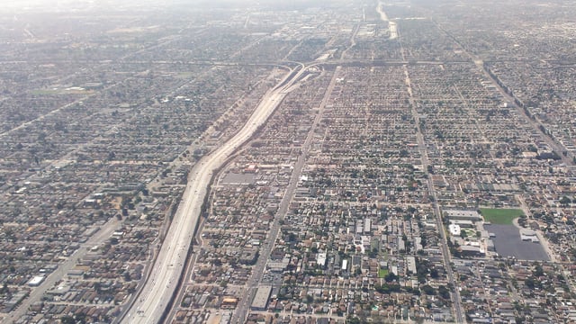 Many areas are completely filled with houses, buildings, roads, and freeways as observed here