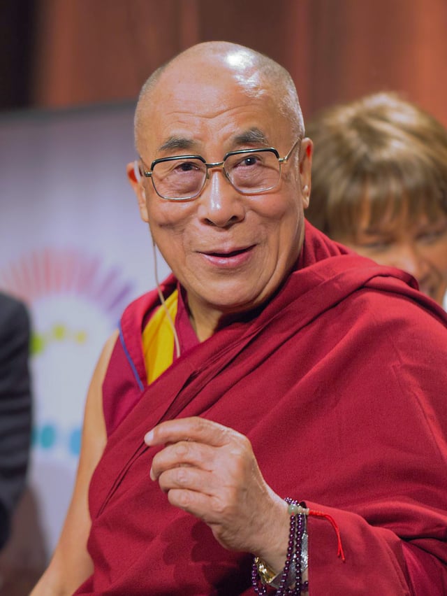 In 2009, Tenzin Gyatso, the 14th Dalai Lama, appeared onstage and presented Raniere with a white scarf.