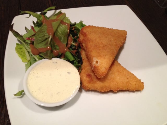 Fried cheese (Smažák), served with tartar sauce and side salad.