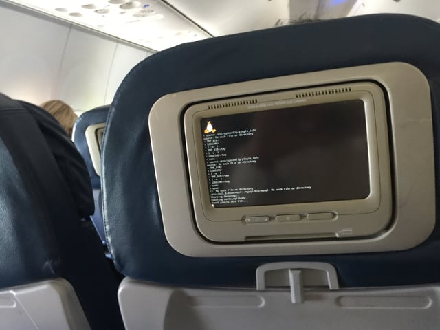 In-flight entertainment system booting up displaying the Linux logo