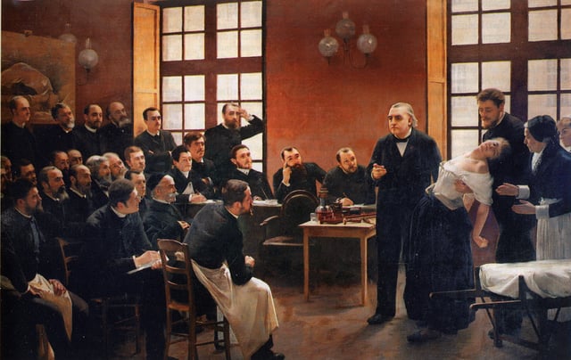 André Brouillet's 1887 A Clinical Lesson at the Salpêtrière depicting a Charcot demonstration. Freud had a lithograph of this painting placed over the couch in his consulting rooms.