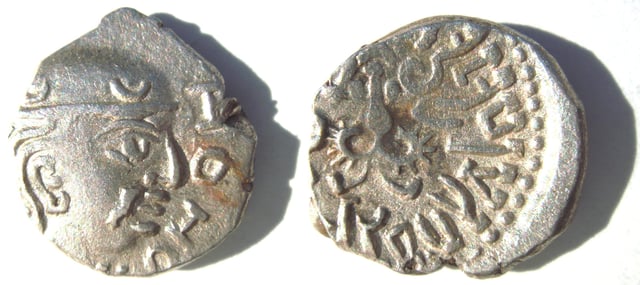 Silver coin of the Gupta King Kumaragupta I (Coin of his Western territories, design derived from the Western Satraps). Obv: Bust of king with crescents, with traces of corrupt Greek script. Rev: Garuda standing facing with spread wings. Brahmi legend: Parama-bhagavata rajadhiraja Sri Kumaragupta Mahendraditya.