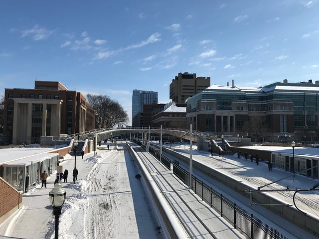 East Bank campus in winter. Ford Hall on the left, Nils Hasselmo Hall on the right of the light rail in the picture.