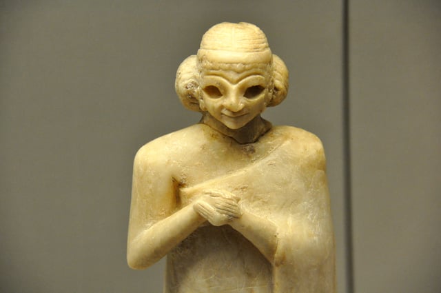 Upper part of a gypsum statue of a Sumerian woman with her hands folded in worship dating to c. 2400 BC, currently held in the British Museum in London