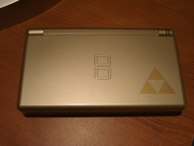 The Gold edition Nintendo DS Lite is emblazoned with The Legend of Zelda's signature Triforce logo.
