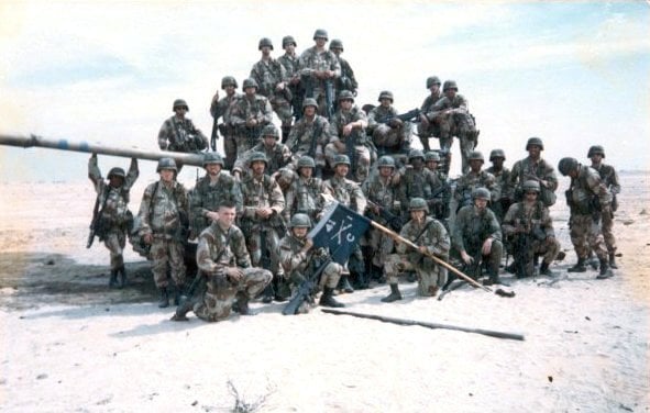 Soldiers of 2nd Platoon, Company C, 1st Battalion, 41st Infantry Regiment pose with a captured Iraqi tank, February 1991