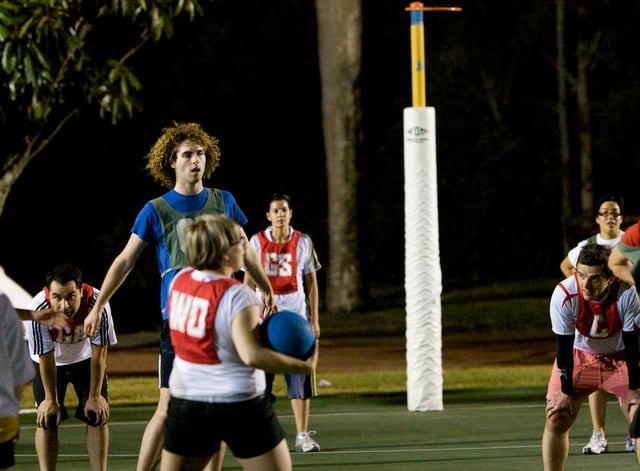 Men and women play together during a mixed netball game in Australia.