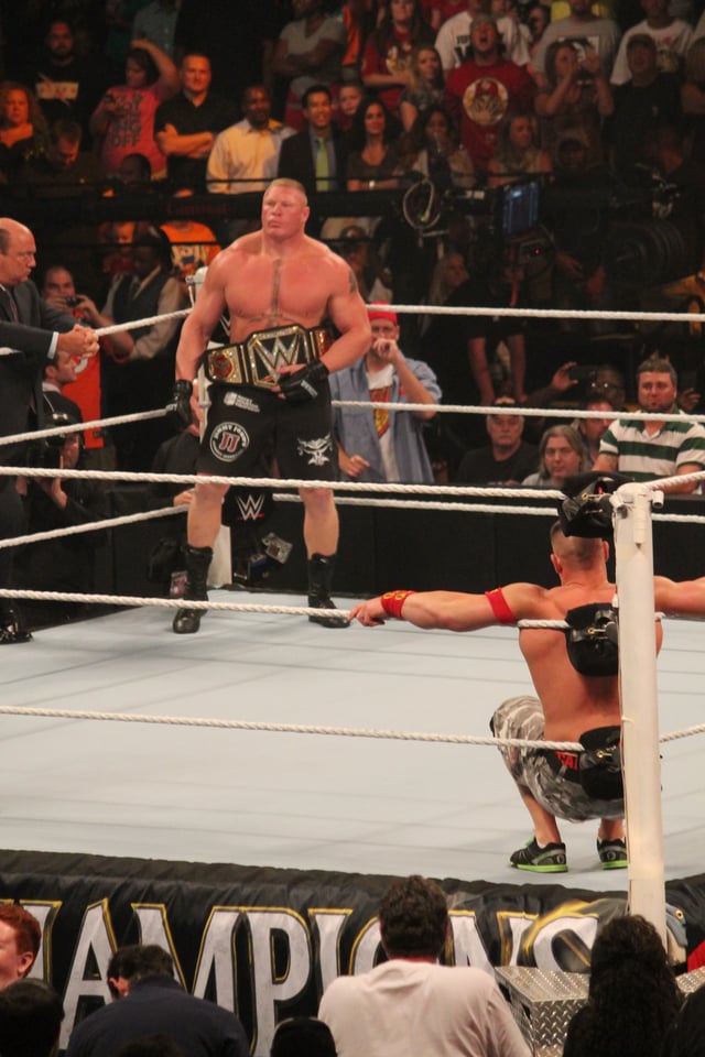 Lesnar, with the WWE World Heavyweight Championship, across the ring from John Cena at the Night of Champions pay-per-view in September 2014