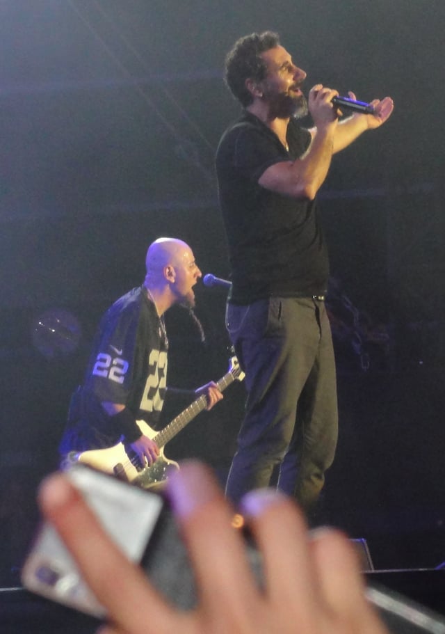 Odadjian with Serj Tankian at a 2013 System of a Down show in Paris