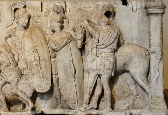 Altar of Domitius Ahenobarbus, c. 122 BC; the altar shows two Roman infantrymen equipped with long scuta and a cavalryman with his horse. All are shown wearing chain mail armour.