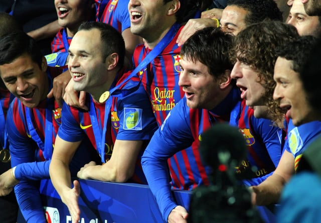 Messi (centre) and his teammates celebrating winning the FIFA Club World Cup in December 2011