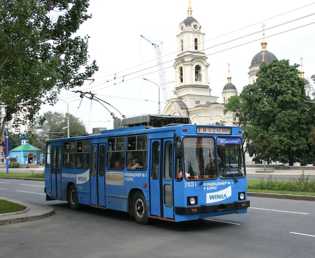 A Donetsk trolley bus with the Cathedral of Transfiguration of Jesus in the background.