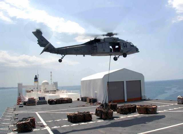 An MH-60S lifting humanitarian supplies from the deck of USNS Comfort in Haiti 2010