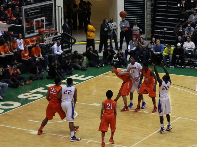 Paul White (#13) and L. J. Peak (#10) box out D. J. Williams (#4) While Jahlil Okafor boxes out Jabari Parker on a Kendrick Nunn free throw during a Chicago Public High School League game between Simeon Career Academy and Whitney M. Young Magnet High School at the Jones Convocation Center