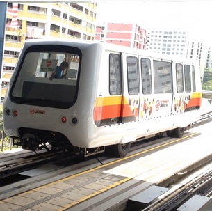 A new Bombardier INNOVIA APM 100 running on the guiderails, in SMRT new livery.