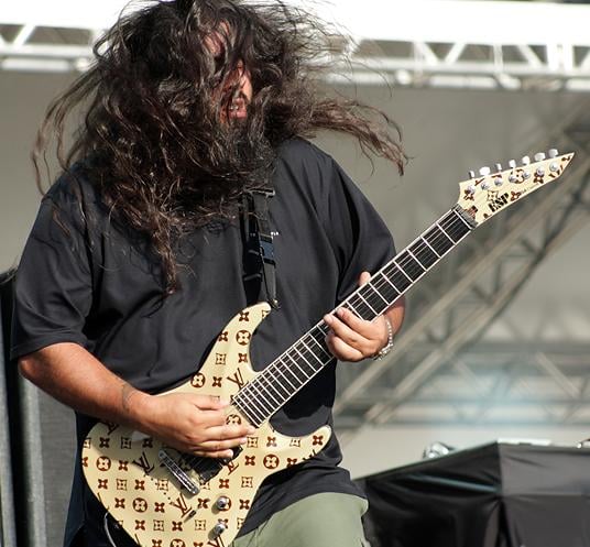 Stephen Carpenter playing a 7-string electric guitar in 2009