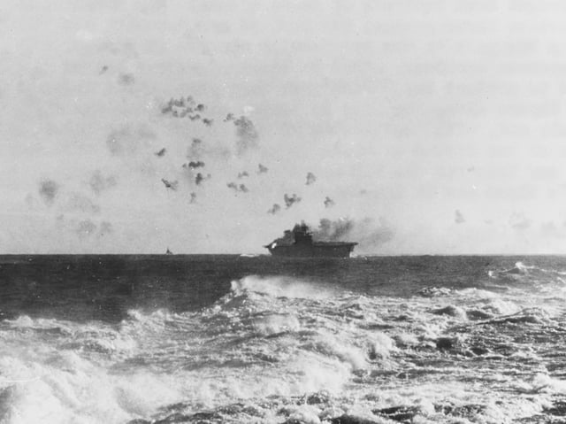 The aircraft carrier USS Enterprise (CV-6) under aerial attack during the Battle of the Eastern Solomons.