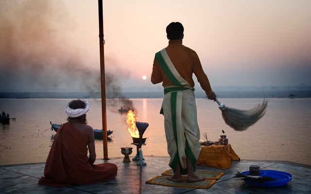 Hindu priest saluting the sun in the Ganges, Varanasi.