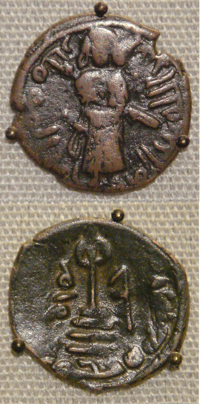 Two coins of the Umayyad Caliphate, based on Byzantine prototypes. Copper falus, Aleppo, Syria, circa 695