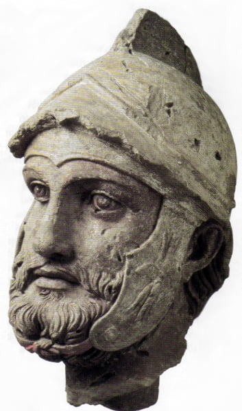 A sculpted head (broken off from a larger statue) of a Parthian soldier wearing a Hellenistic-style helmet, from the Parthian royal residence and necropolis of Nisa, Turkmenistan, 2nd century BC