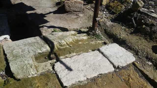 One of the broken stone doors at entrance to one of the caves