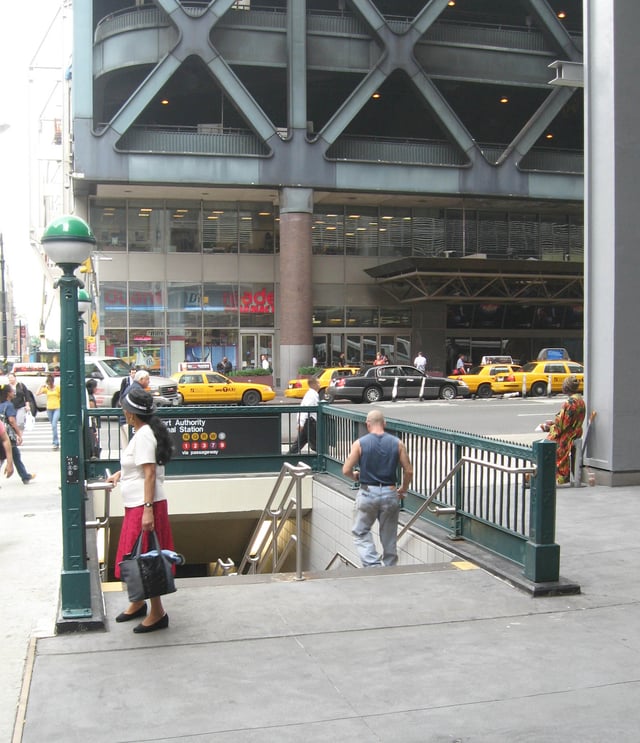 Subway entrance and cab stand on Eighth Avenue. Extensive underground passageways connect various stations & PABT.