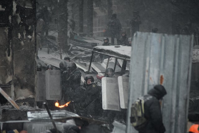 Anti-riot police forces consisting of Internal Troops holding protective position and Berkut special policemen shooting in Kyiv riots, 22 January