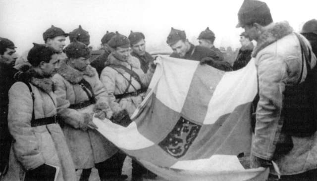 Red Army soldiers display a captured Finnish banner, March 1940