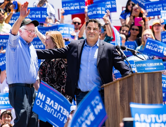 Uygur with Bernie Sanders at a campaign rally in California in 2016