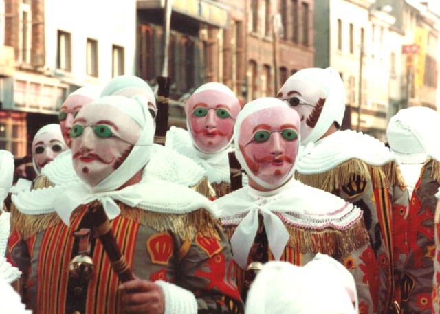 The Gilles of Binche, in costume, wearing wax masks