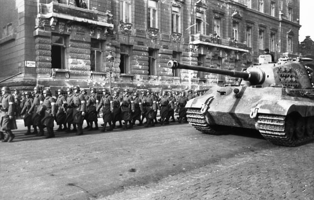 A German Tiger II with a column of Arrow Cross soldiers in Budapest